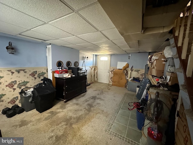 basement featuring carpet flooring and a drop ceiling