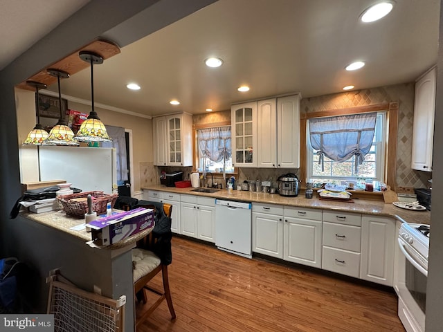 kitchen featuring white appliances, pendant lighting, white cabinetry, ornamental molding, and sink