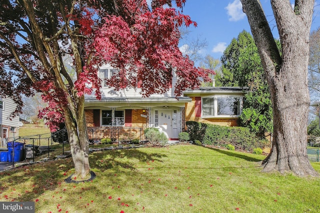 view of front facade featuring a front lawn and covered porch