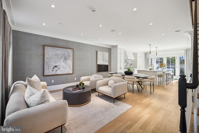 living room featuring light hardwood / wood-style flooring and ornamental molding