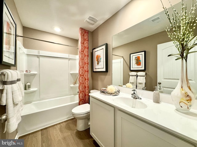 full bathroom featuring wood-type flooring, vanity, toilet, and shower / bath combination with curtain