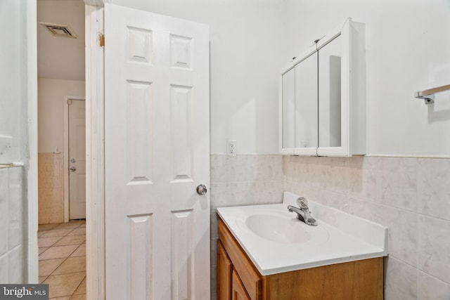 bathroom with vanity, tile walls, and tile patterned flooring