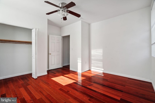 unfurnished bedroom featuring a closet, ceiling fan, and dark wood-type flooring