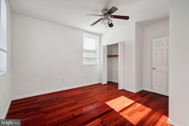 unfurnished bedroom with a closet, ceiling fan, and dark hardwood / wood-style floors