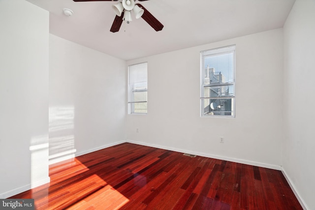 empty room with hardwood / wood-style floors and ceiling fan