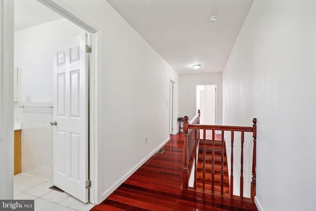 hall featuring tile walls and hardwood / wood-style flooring