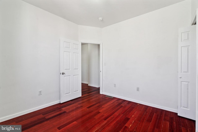 empty room featuring dark wood-type flooring