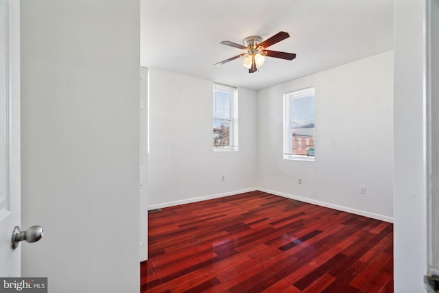 empty room featuring dark hardwood / wood-style floors and ceiling fan