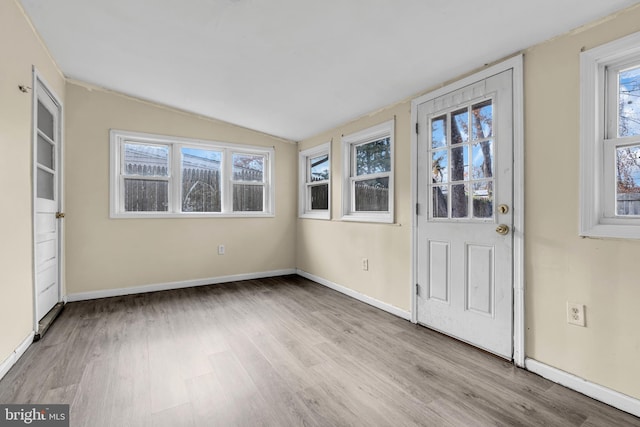 unfurnished sunroom with lofted ceiling