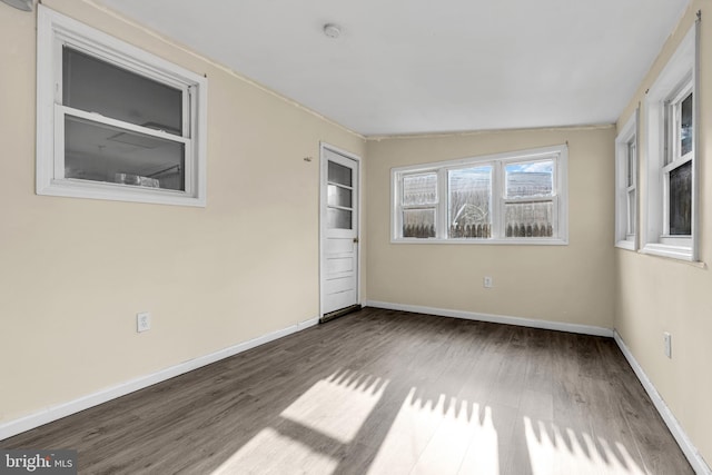 empty room featuring dark hardwood / wood-style floors and vaulted ceiling