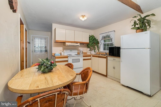 kitchen featuring white appliances, ventilation hood, and white cabinets