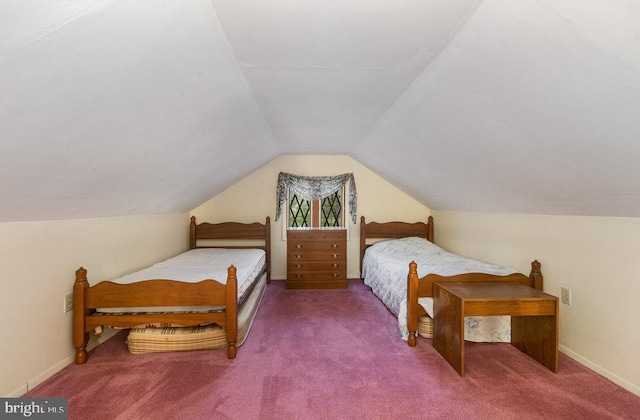 carpeted bedroom with lofted ceiling and baseboards