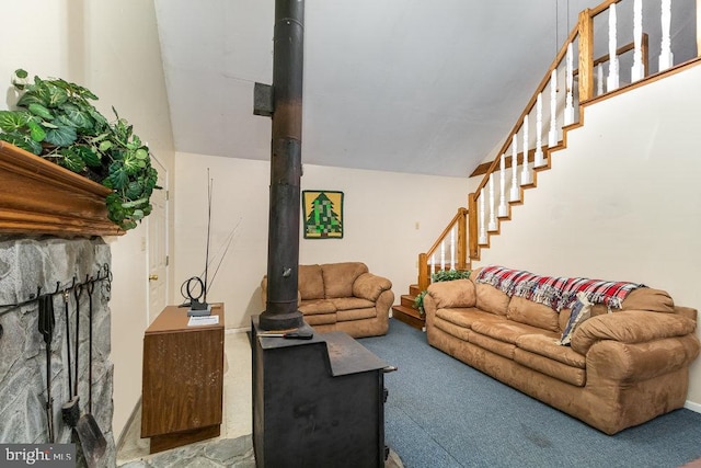 carpeted living room featuring vaulted ceiling and a wood stove