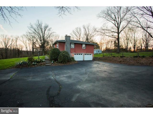 property exterior at dusk featuring a garage