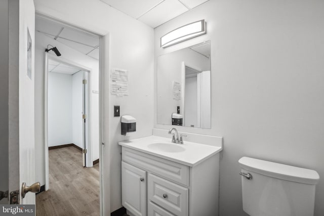 bathroom featuring hardwood / wood-style flooring, vanity, and toilet