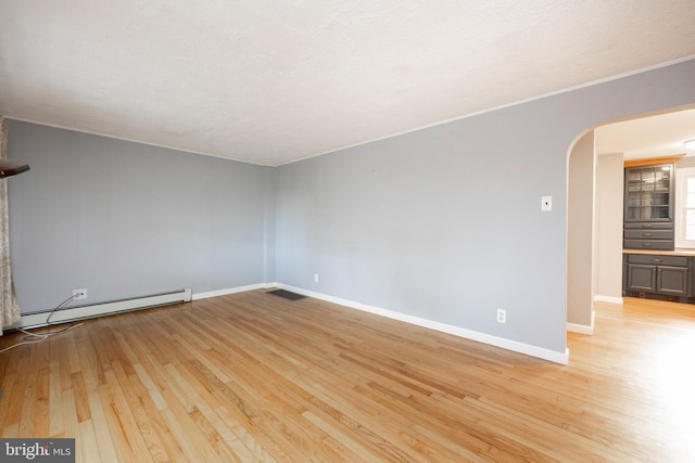 unfurnished room featuring a textured ceiling, light hardwood / wood-style floors, and baseboard heating