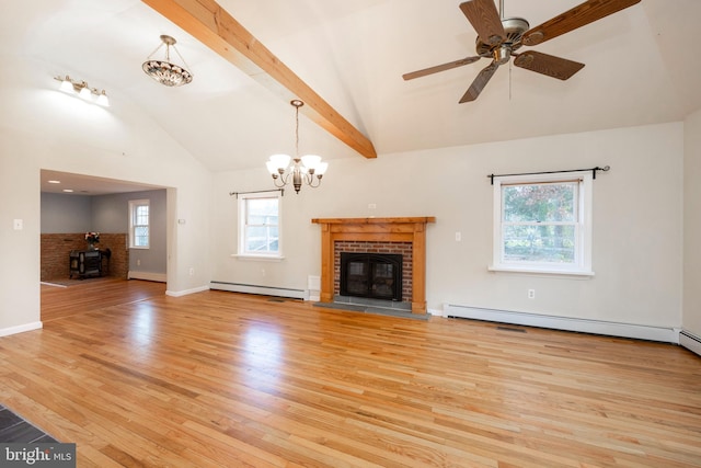 unfurnished living room with a fireplace, a baseboard radiator, light hardwood / wood-style flooring, and a wealth of natural light