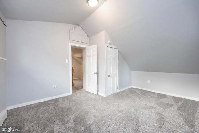 bonus room featuring lofted ceiling and carpet floors