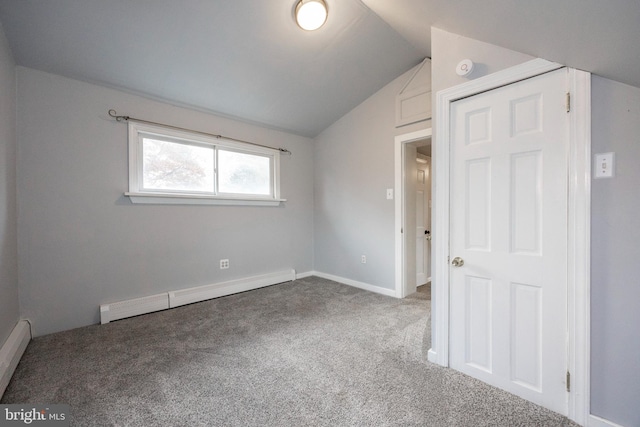 unfurnished bedroom with carpet, lofted ceiling, a closet, and a baseboard heating unit