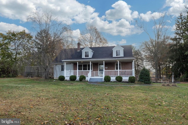 cape cod-style house featuring a porch and a front lawn