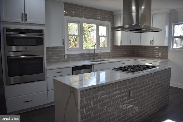 kitchen with wall chimney range hood, sink, appliances with stainless steel finishes, tasteful backsplash, and dark hardwood / wood-style flooring