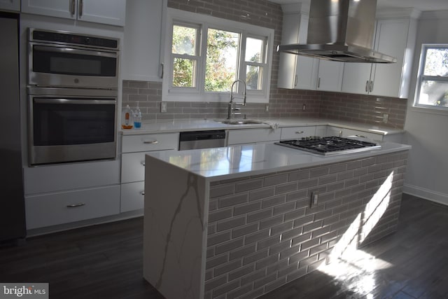 kitchen featuring sink, dark hardwood / wood-style floors, white cabinetry, and wall chimney range hood