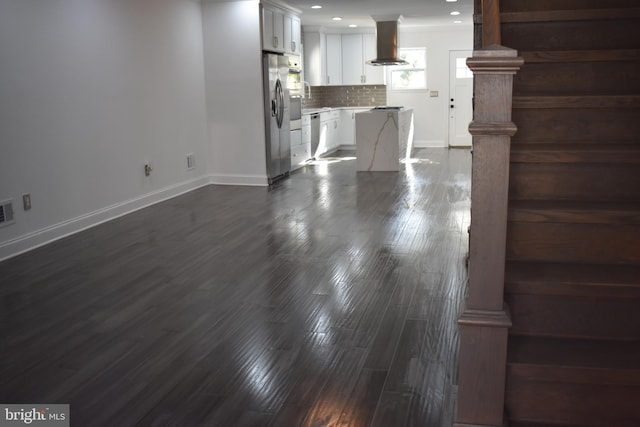 unfurnished living room featuring sink and dark hardwood / wood-style floors