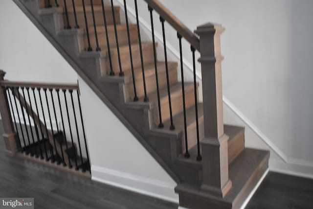 staircase with hardwood / wood-style floors