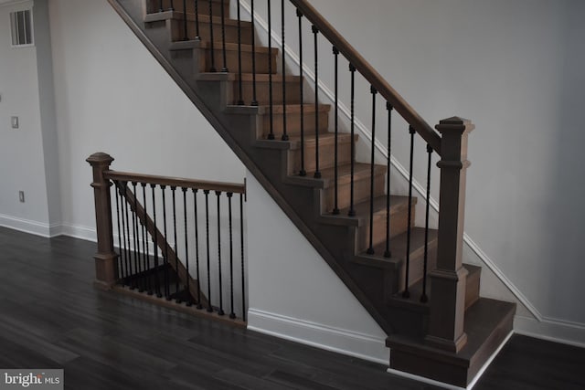 staircase with hardwood / wood-style flooring