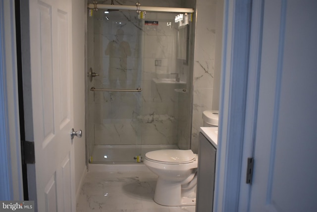 bathroom with vanity, toilet, and a shower with shower door