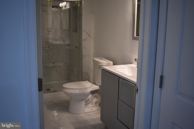 bathroom featuring vanity, toilet, and a shower with shower door