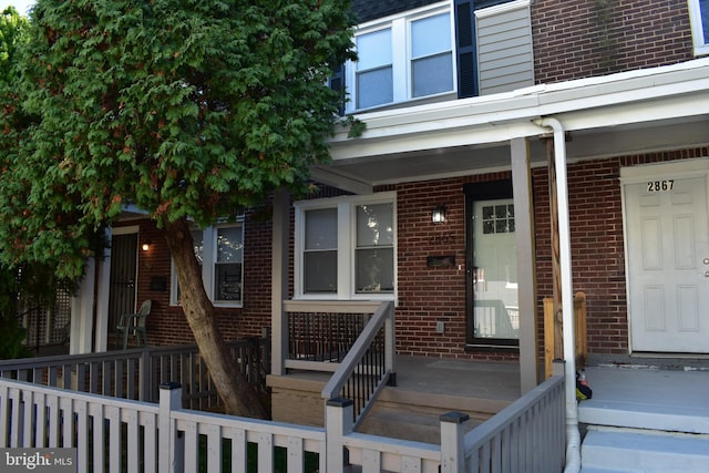 view of exterior entry with covered porch