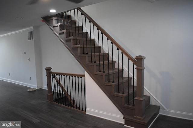 stairway with crown molding and hardwood / wood-style floors