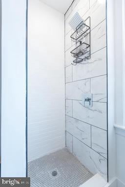 bathroom with a tile shower