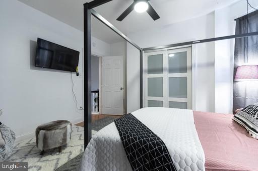 bedroom featuring a closet, ceiling fan, and hardwood / wood-style floors