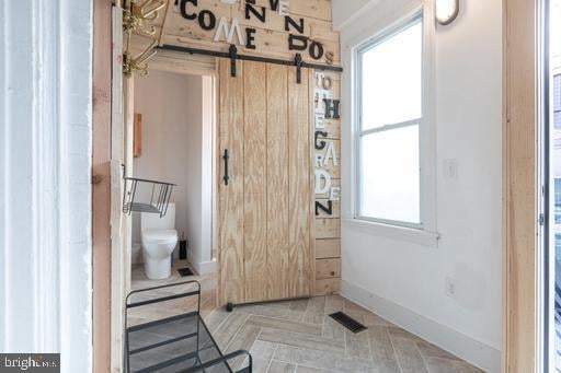 bathroom featuring toilet and a wealth of natural light