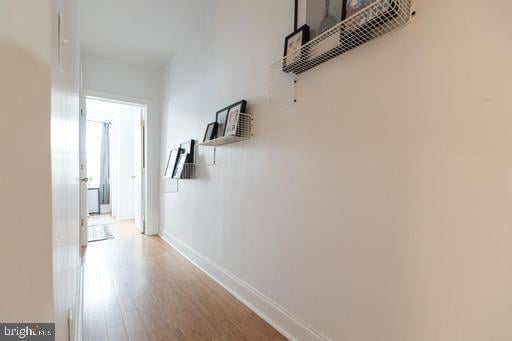 corridor with light hardwood / wood-style flooring