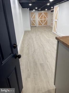 basement featuring light hardwood / wood-style flooring