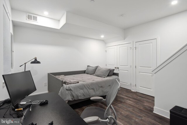 bedroom with dark wood-type flooring