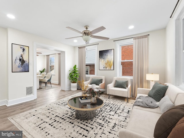 living room with hardwood / wood-style floors and ceiling fan