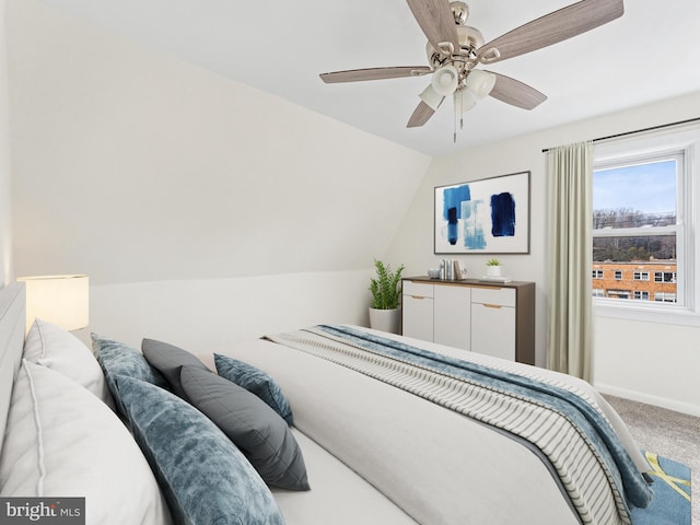 bedroom with carpet flooring, ceiling fan, and vaulted ceiling