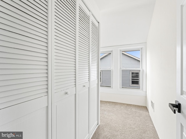 corridor with light colored carpet