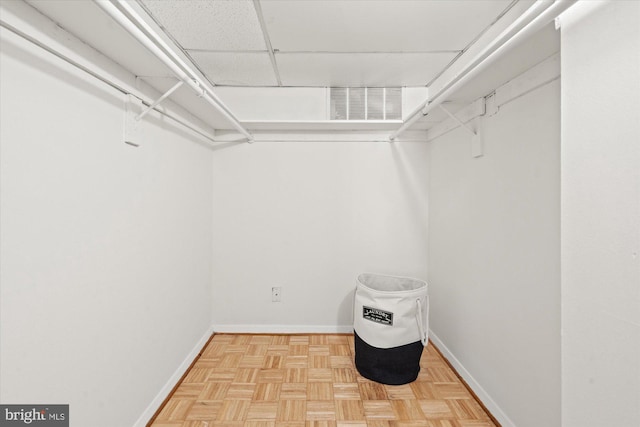 spacious closet featuring parquet floors