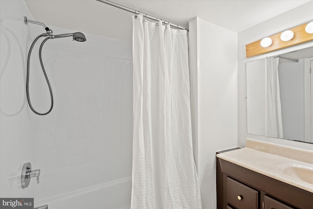 bathroom with shower / bath combo and vanity