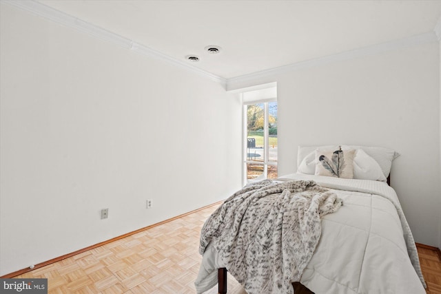 bedroom with light parquet flooring and crown molding