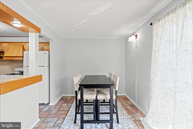 dining space with a textured ceiling