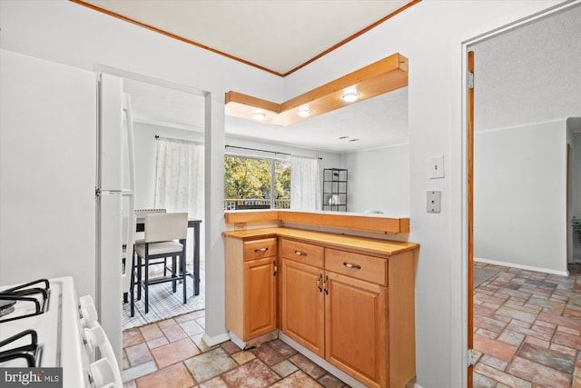 kitchen featuring a textured ceiling and gas range gas stove