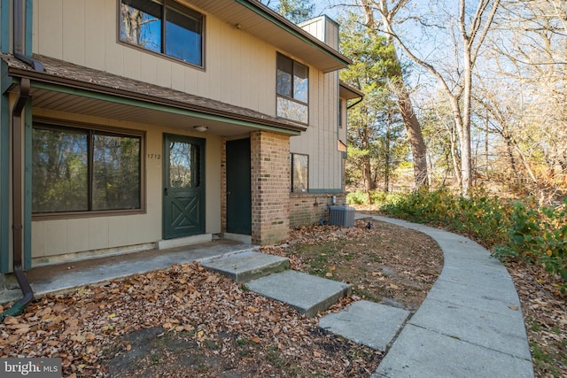 doorway to property with central AC unit