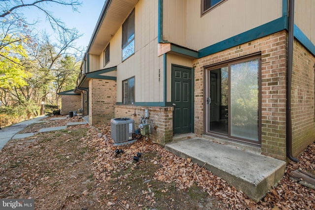 doorway to property with central AC unit