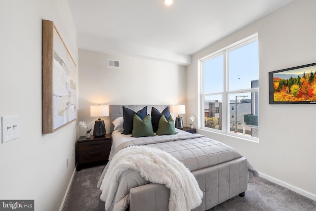 carpeted bedroom featuring multiple windows